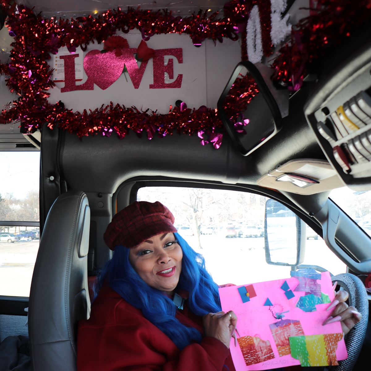  Yvonne Johnson shows off art from a student in her decorated bus